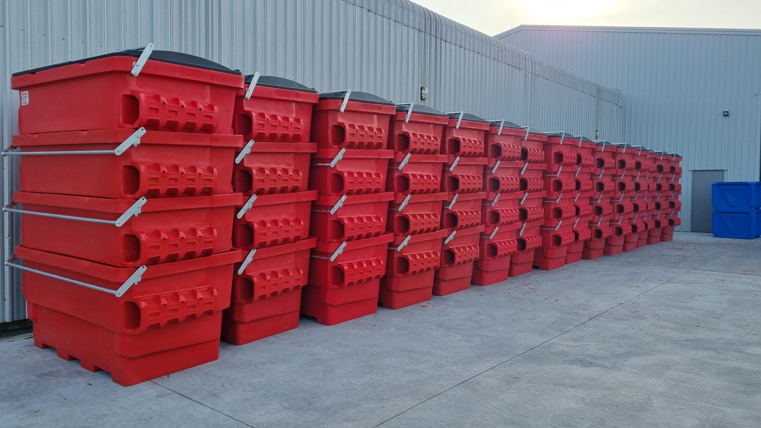 red industrial grade FEL skip bins stacked