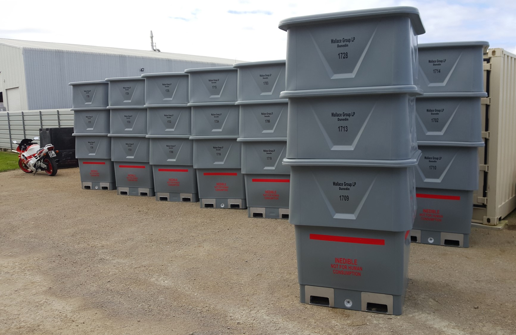 stack grey offal bins outside